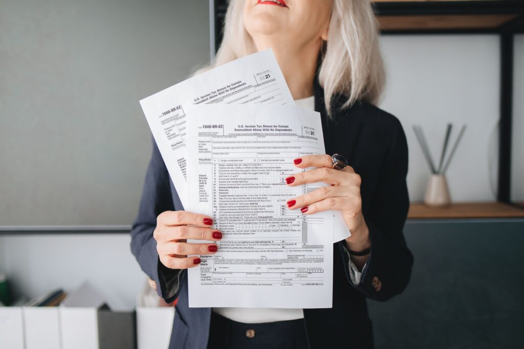 a lady holding tax filing document