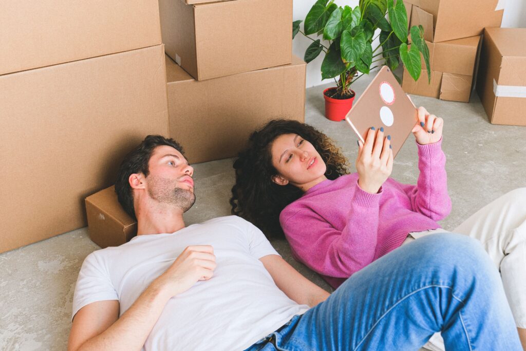 a couple lying on the floor as new renters